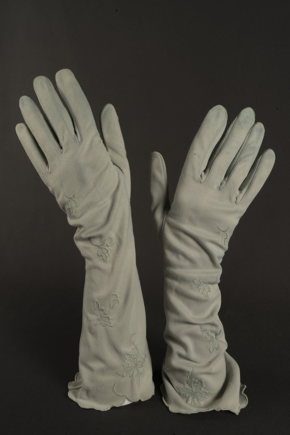 Pair of green embroidered gloves