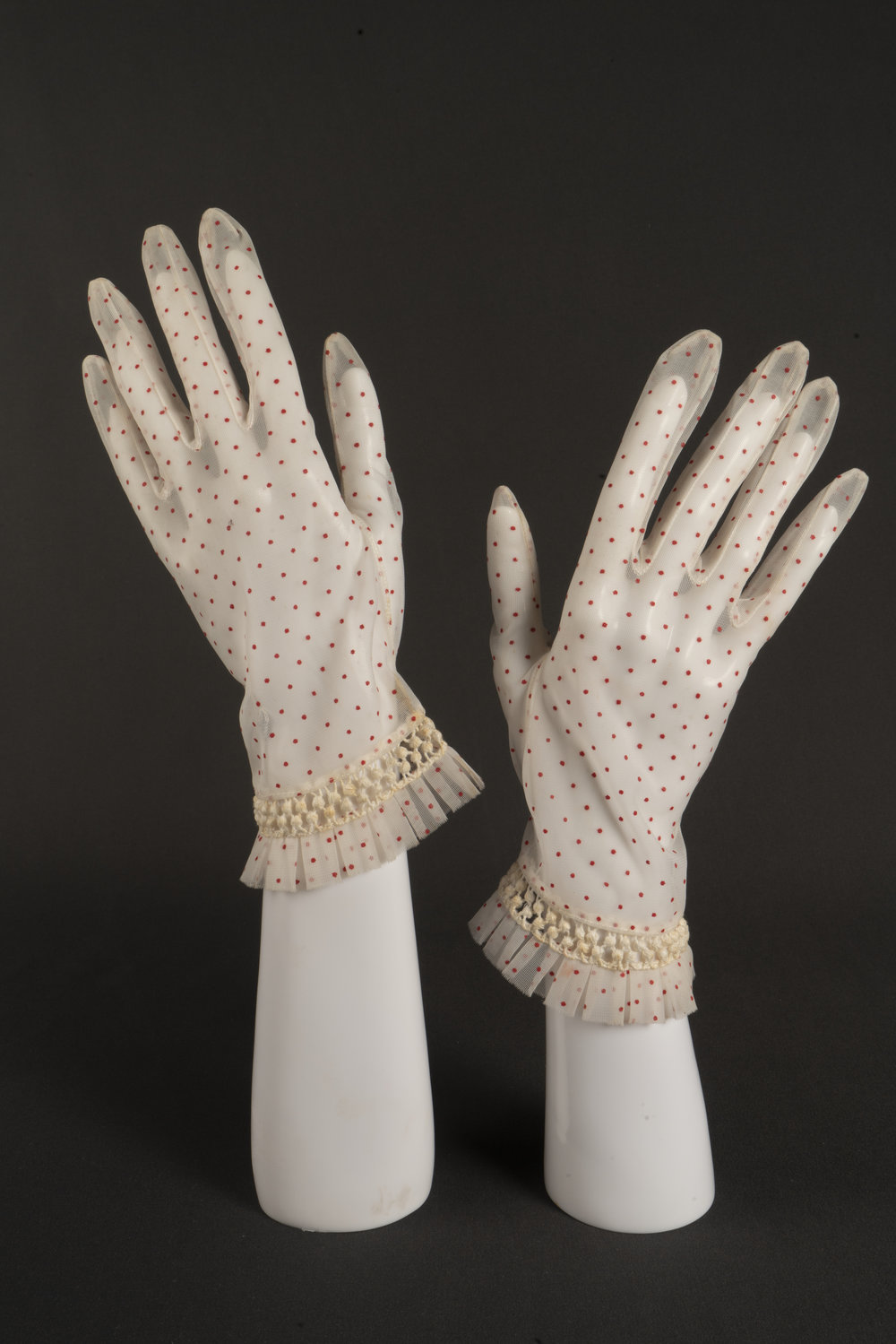 Pair of cream &amp; red hail spot gloves, c. 1960