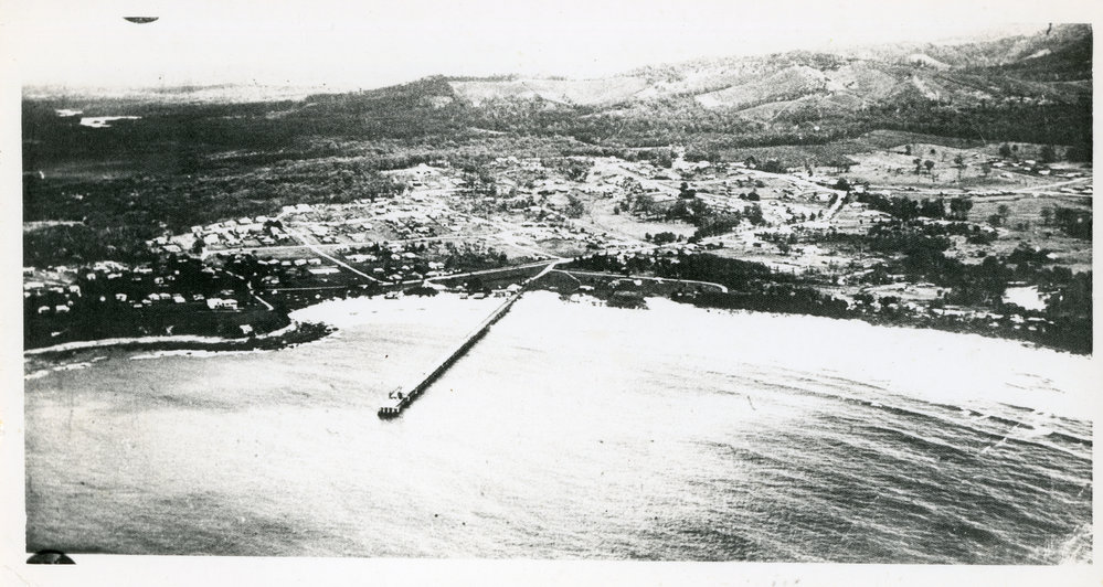 Aerial view of Woolgoolga township and jetty, mid-1940s