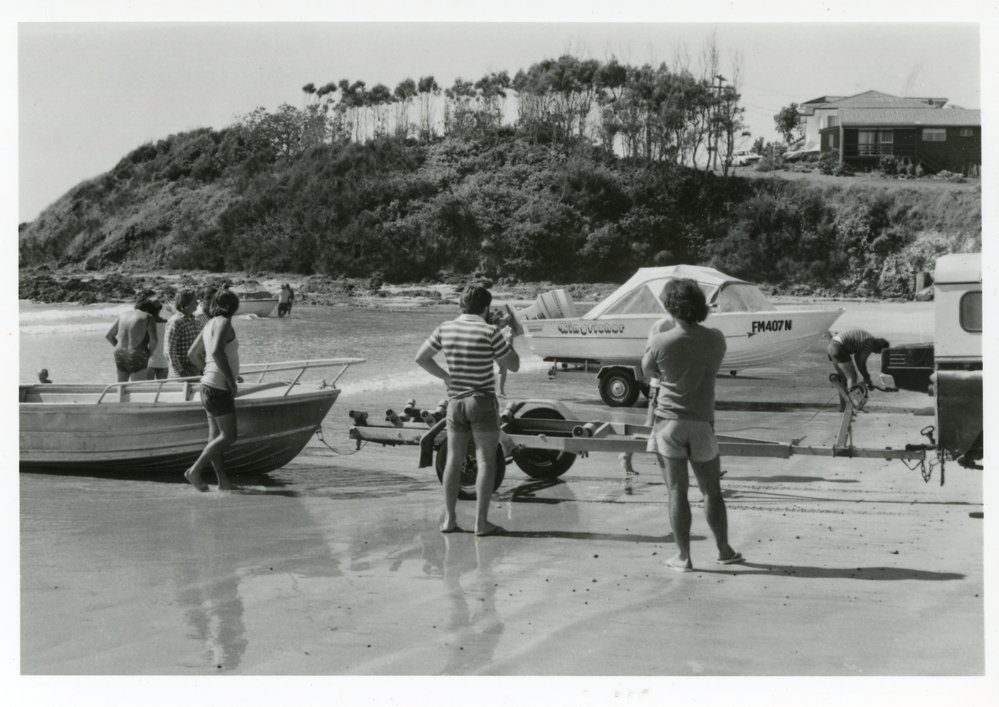 Motorboats and boat trailers at Woolgoolga Beach, 1980s