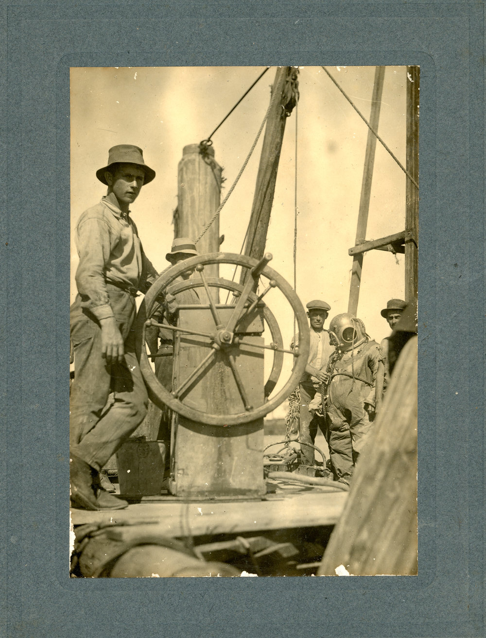 Jetty diver Jim Pearce in suit to inspect piles, c.1940s
