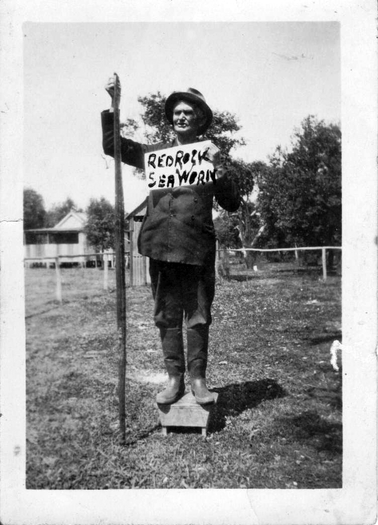 Tom Richards holding 7 foot long carpet snake, Red Rock, 1930