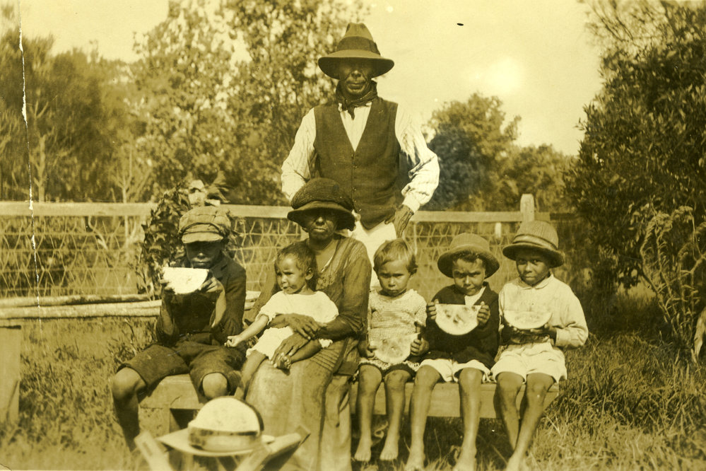 Skinner Family eating watermelon, Red Rock, 1924