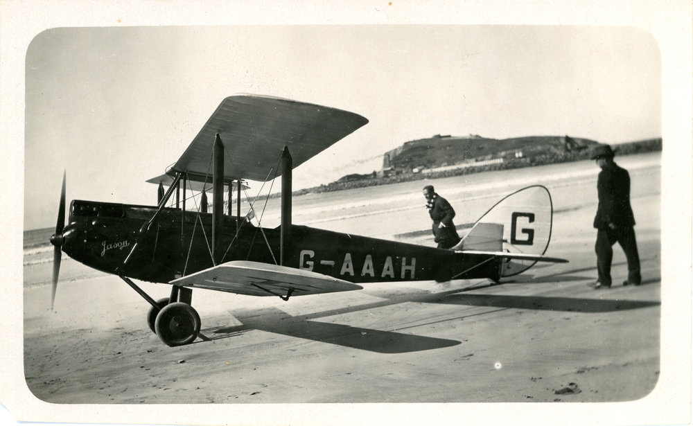Two men with aeroplane at the beach, 4 June 1930
