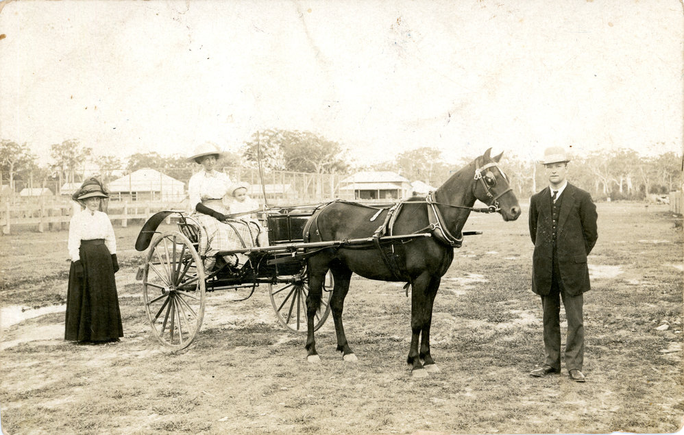 Captain Colvin standing by two women and child with a horsedrawn buggy, c. 1900
