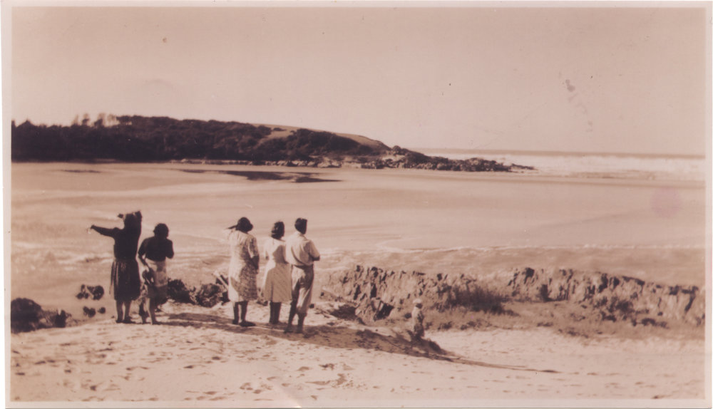 Frank Howe and family observing the rushing outflow at the mouth of Bonville Creek, June 1950  