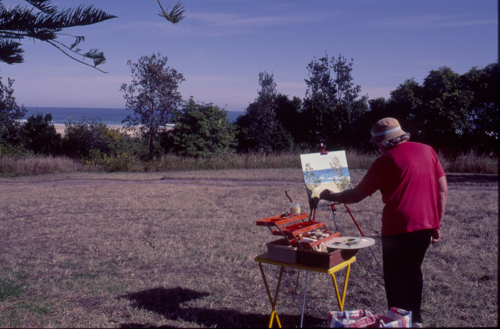 Woman painting 'en plein air' by the beach