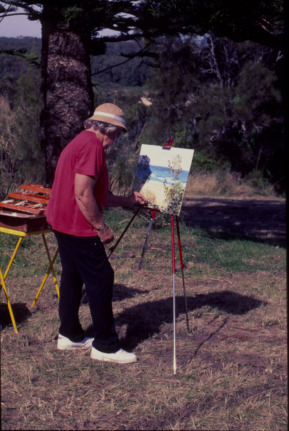 Woman painting 'en plein air' by the beach
