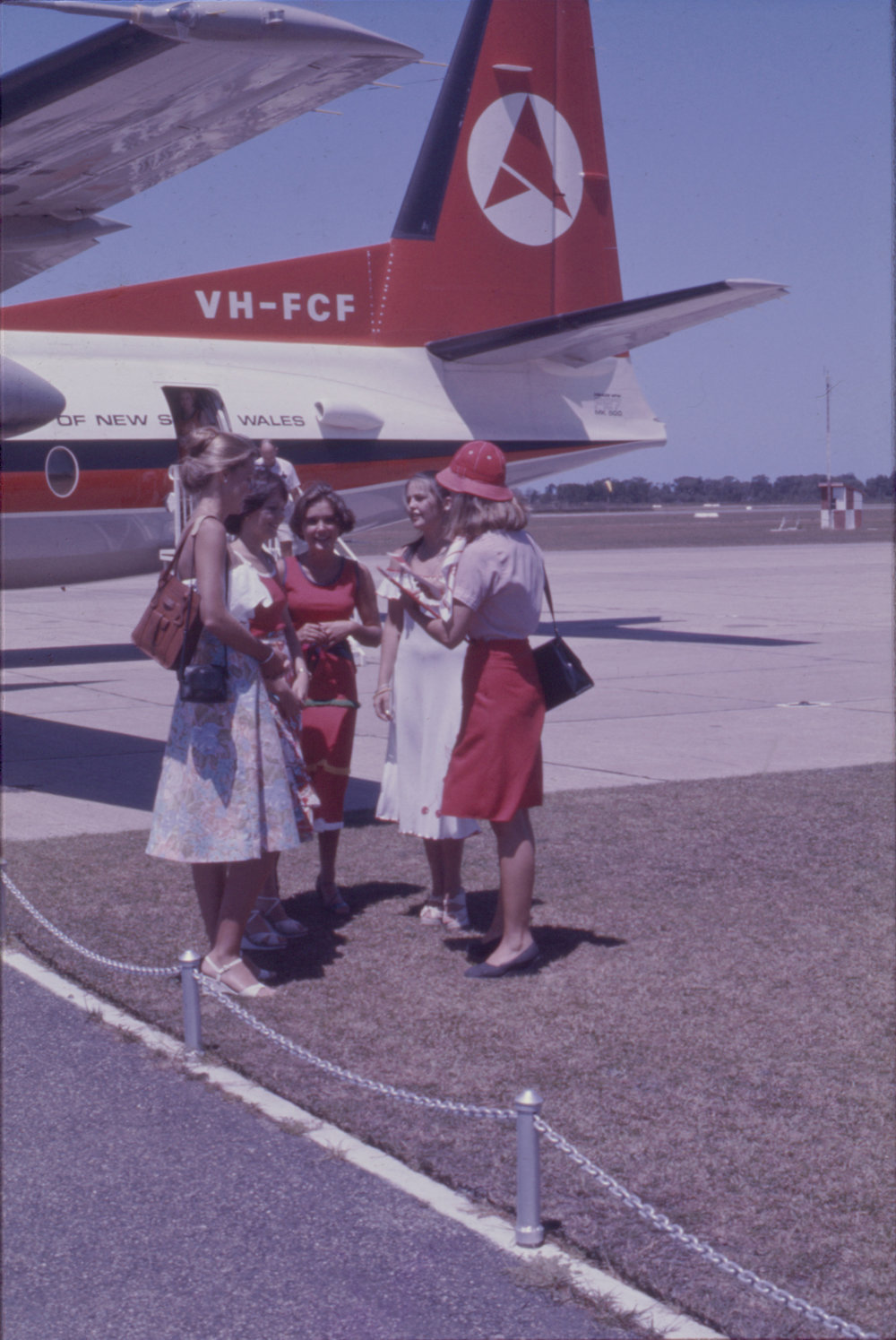 Women standing next to Ansett Fokker F-27 Friendship aeroplane, Coffs Harbour Airport