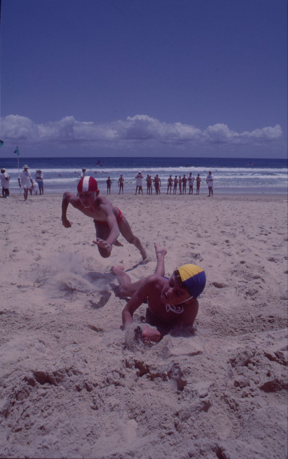 Two boys in a beach flags race