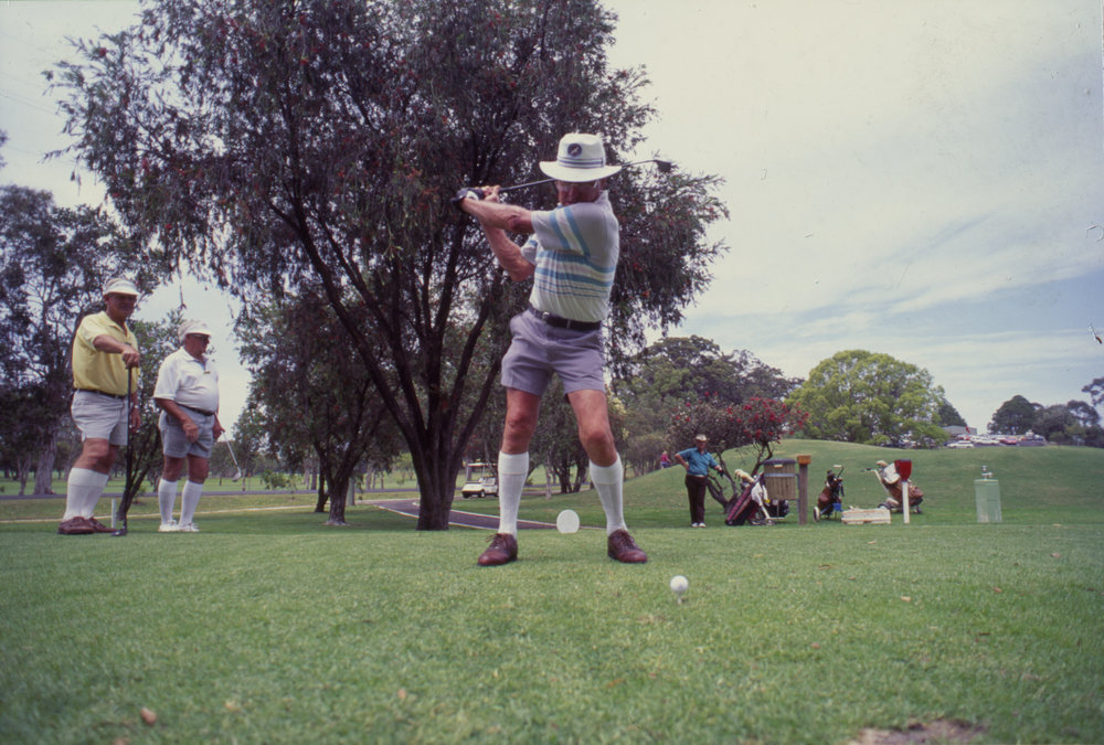 Golfer mid-swing