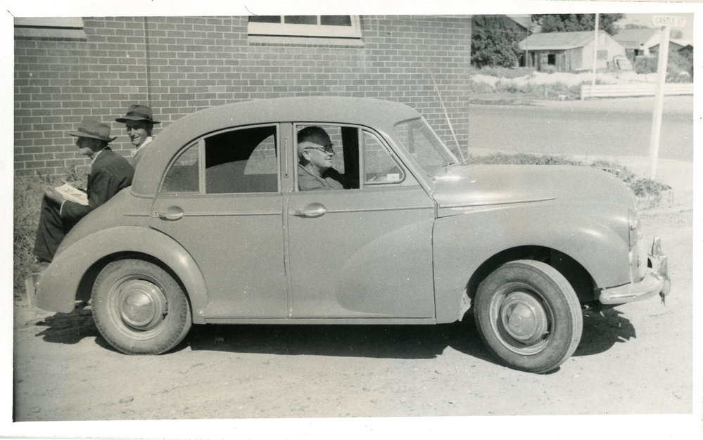 A Morris Minor with three men, c. 1950s