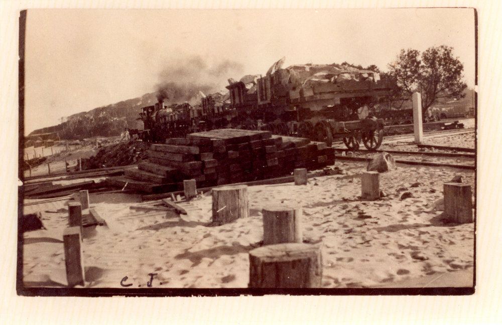 Steam train transporting rocks to the proposed northern breakwall, 1915 - 1918 