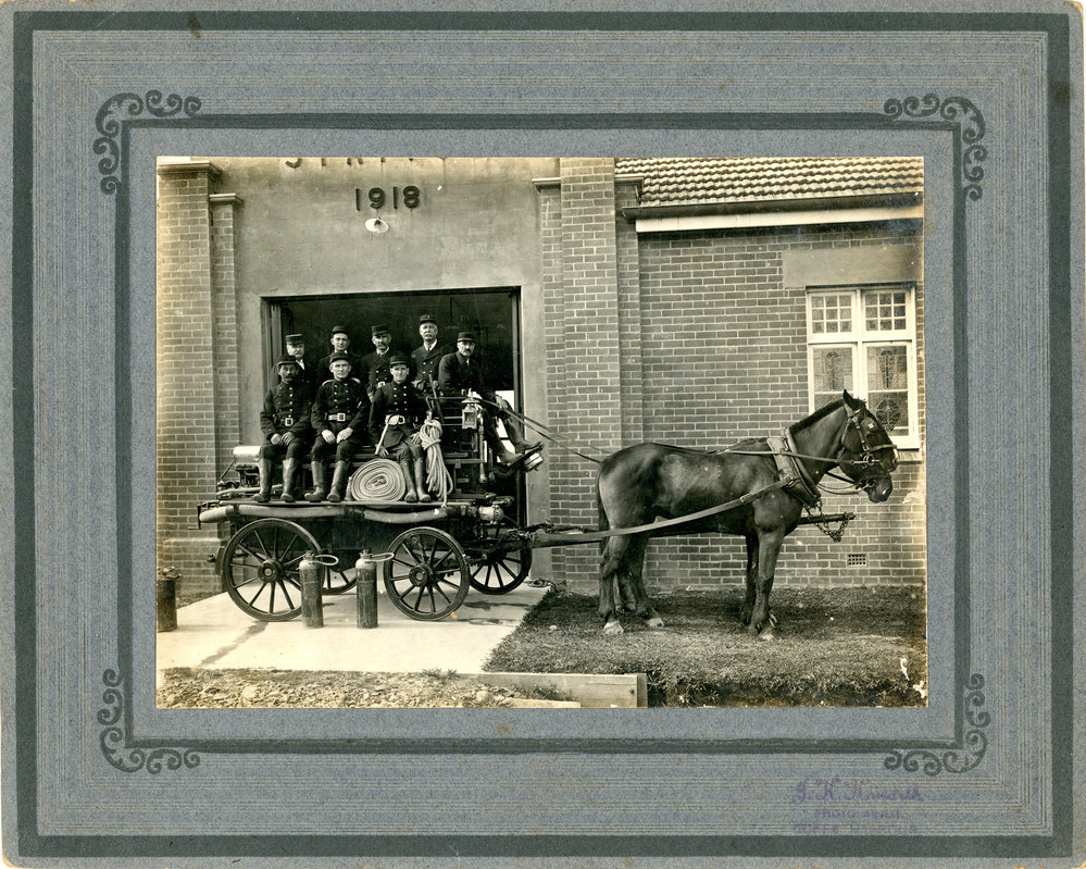 Fire Brigade members sitting on a horsedrawn fire engine, 4 February 1919 
