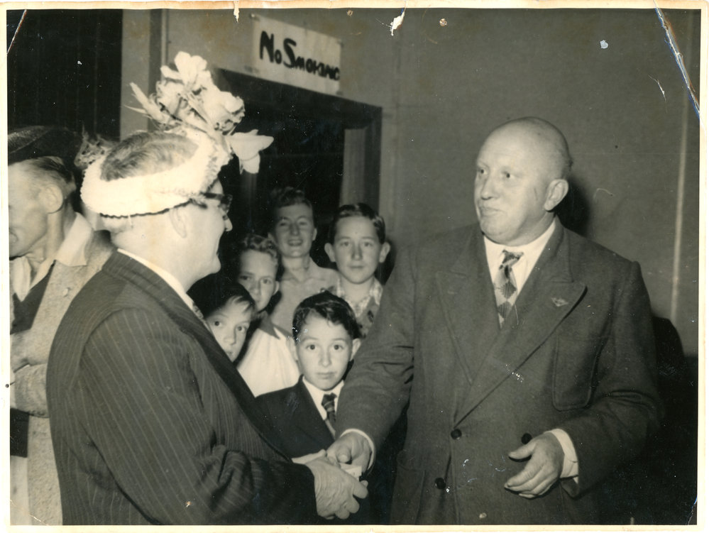 George England tries not to laugh at Jack Gerard's hat, c. 1950 - 1951