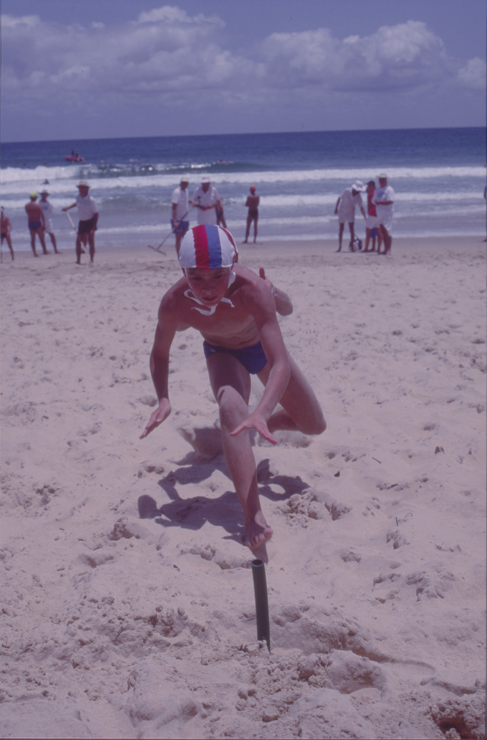 Two boys in a beach flags race