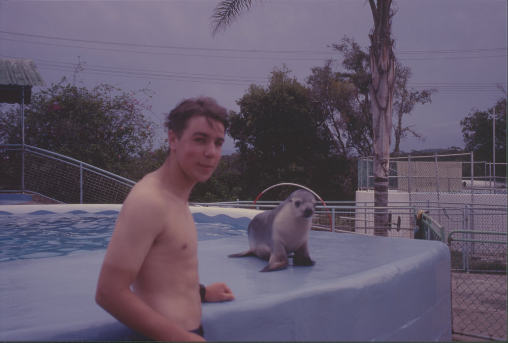 Young man with baby seal, Pet Porpoise Pool