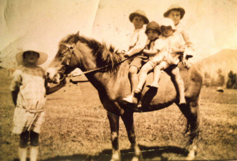 Four children on a pony and one lead