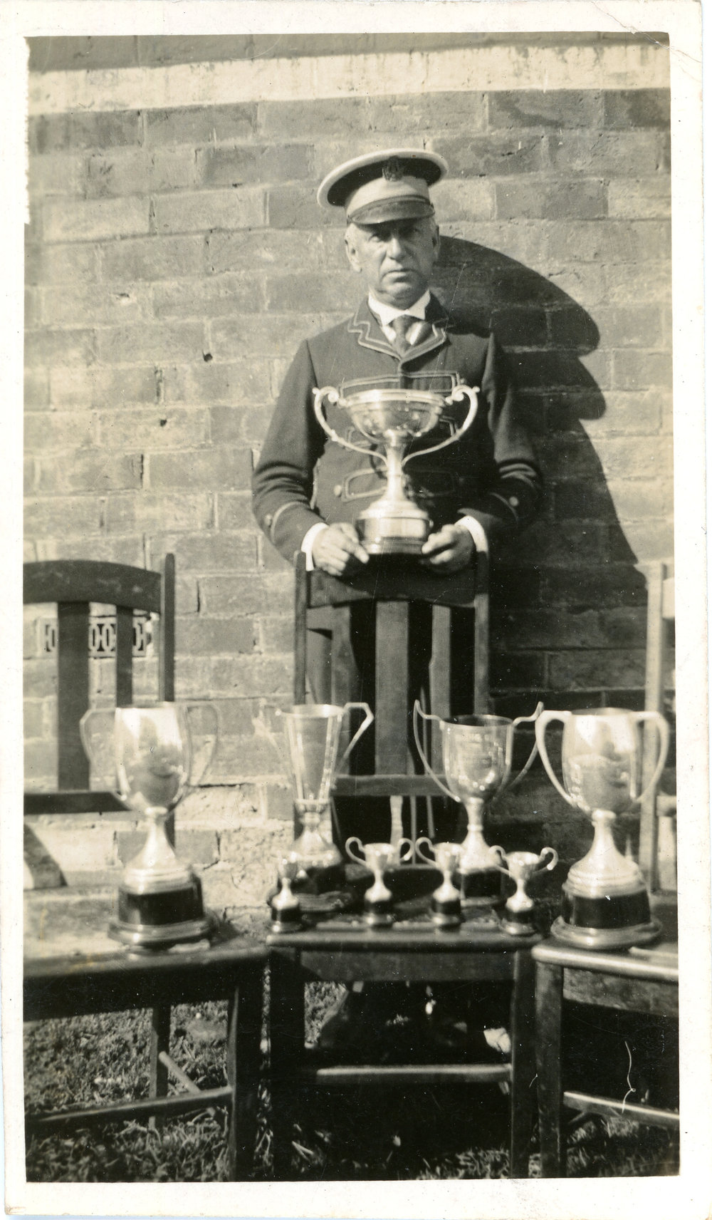 Bandmaster Jack Frame with prize cups won at the North Coast Bands' Association Contest, 1 March 1935 