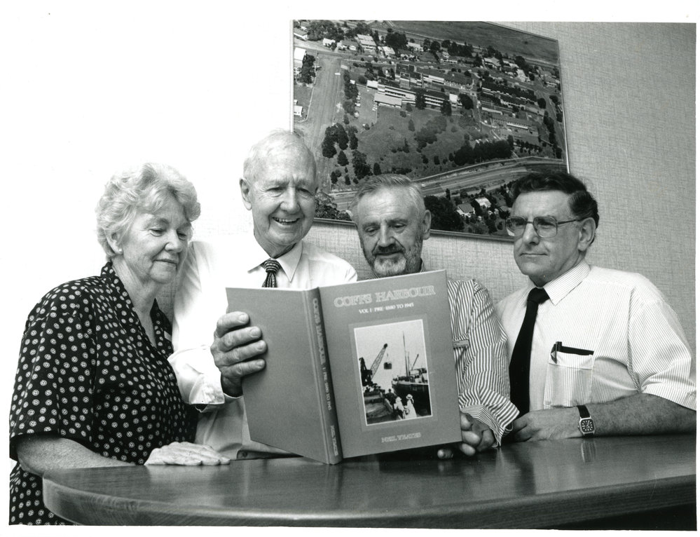Neil Yeates signs a copy of his Coffs Harbour history, 1990