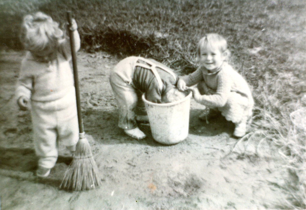 Laura, Ruth and Nancy play with bucket and broom