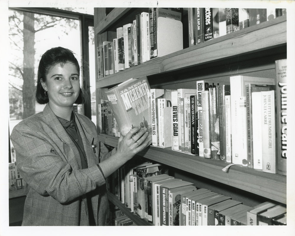Woolgoolga Library assistant Janine shelving books, 15 August 1988