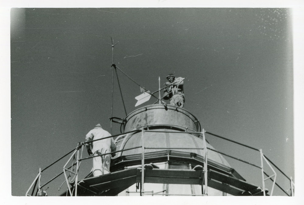 Fixing the weather vane on top of the Smoky Cape Lighthouse, 1977 