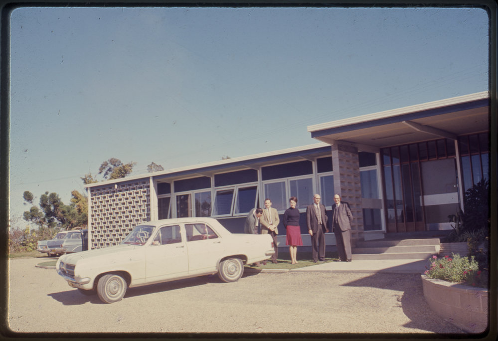 Group of people in front of building, c. 1966