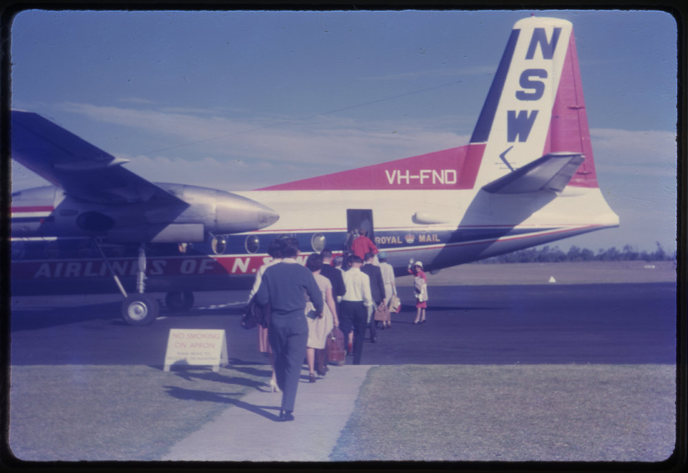 Passengers boarding airplane, Coffs Harbour Airport, c. 1962