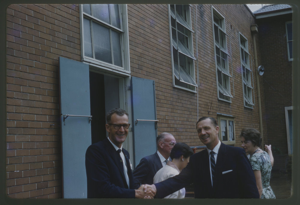 Two Rotarians shake hands, Coffs Harbour Public School, c. 1960s