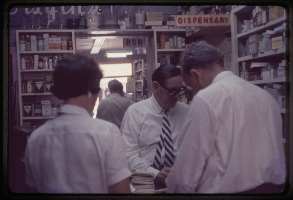 Arnold Forsyth in his pharmacy, c. 1960s