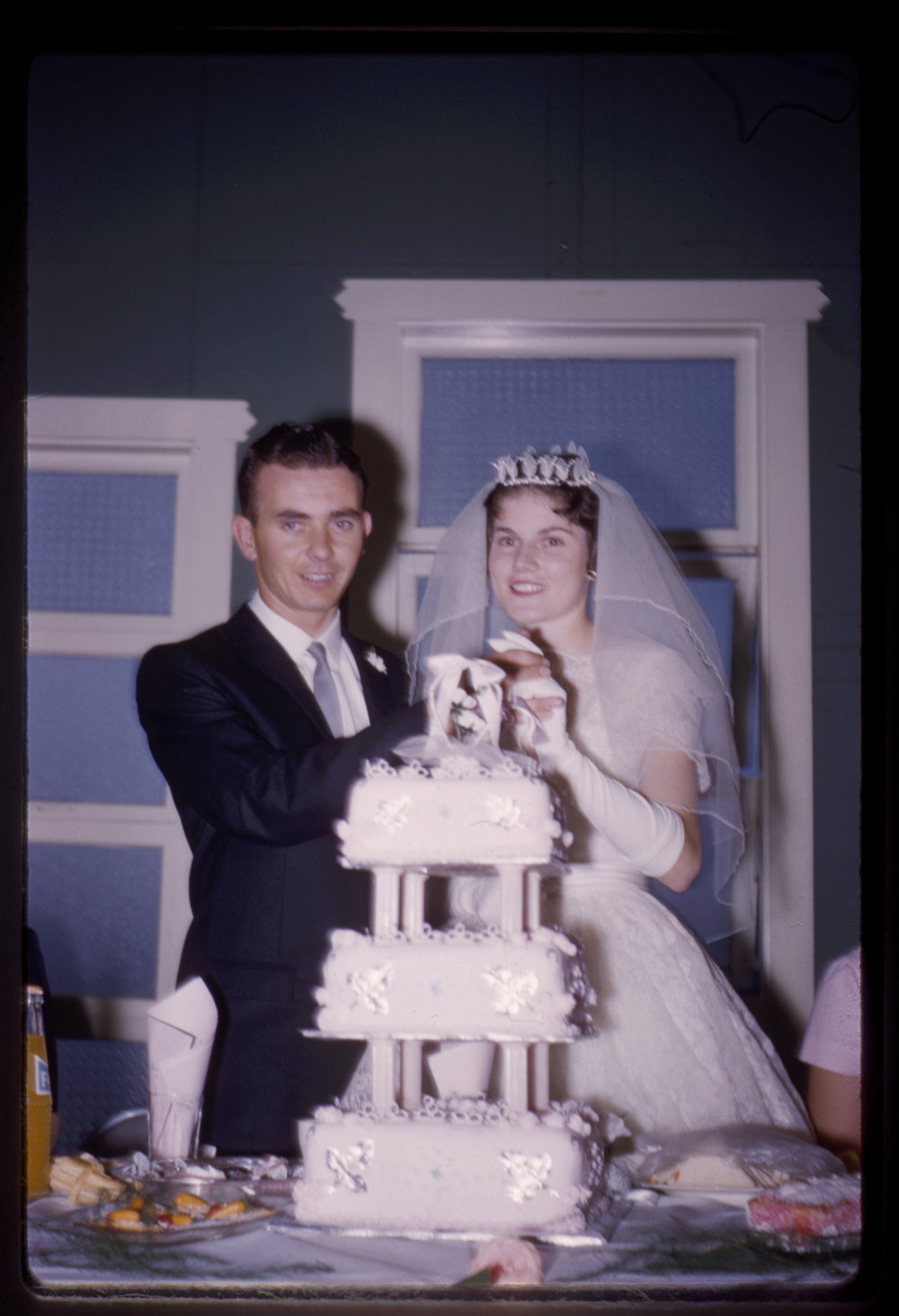 Bride &amp; Groom cut wedding cake, c. 1960s