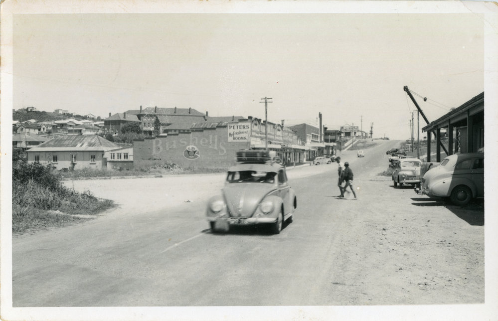 A Volkswagon motors down High Street at the Jetty village, 1950s