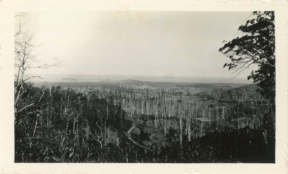 A road snakes down to the township, c. 1930