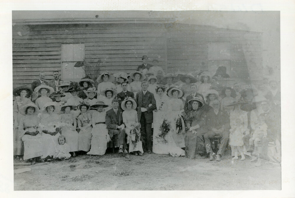 Wedding portrait of large wedding party outside a building, 1905 - 1915