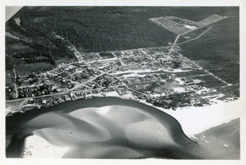 Aerial view over a coastal town, 3 June 1950