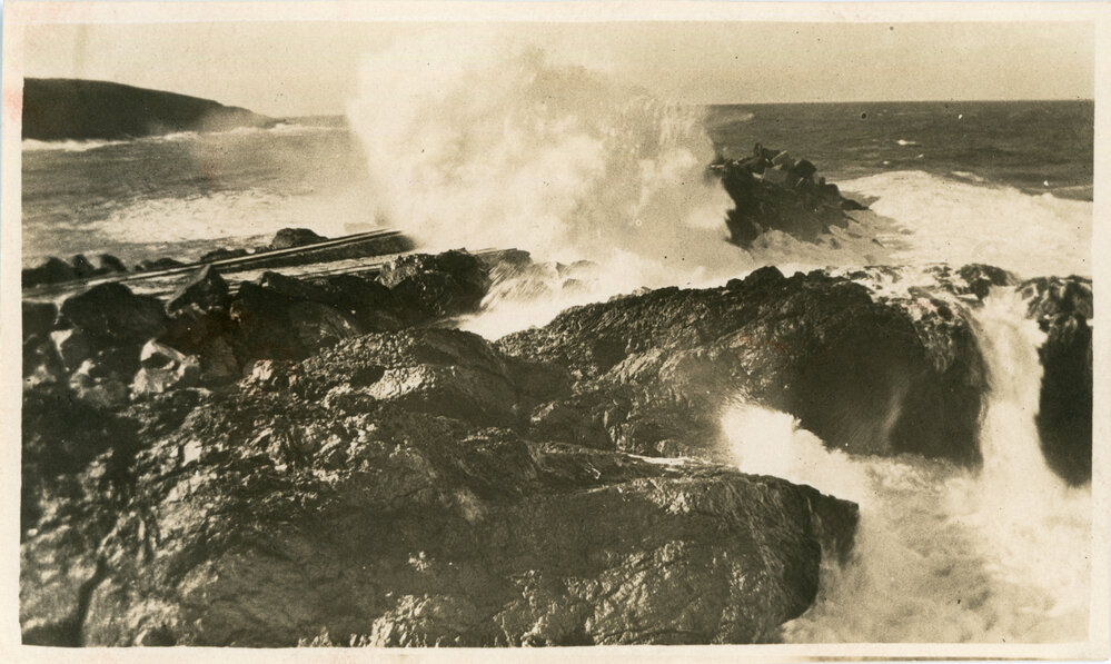 Waves break over the breakwall tramway, c.1933