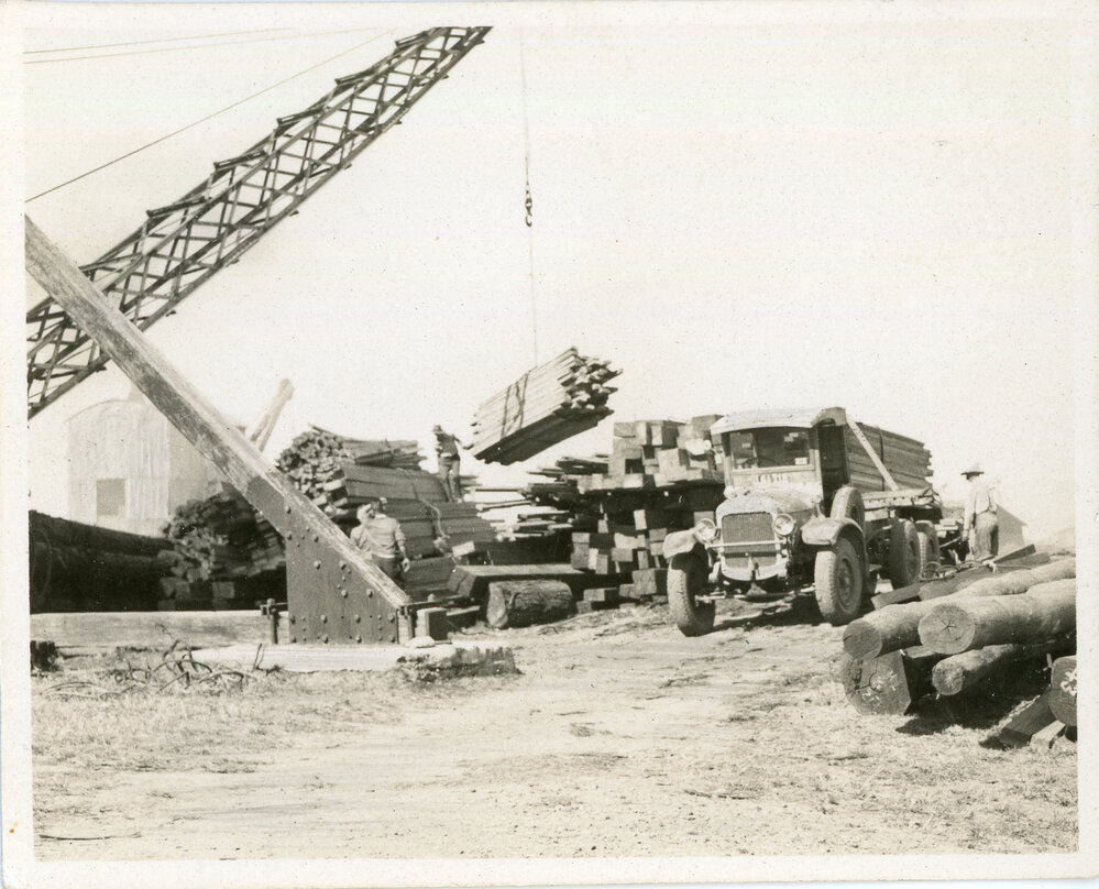 A crane transfers timber, 1936