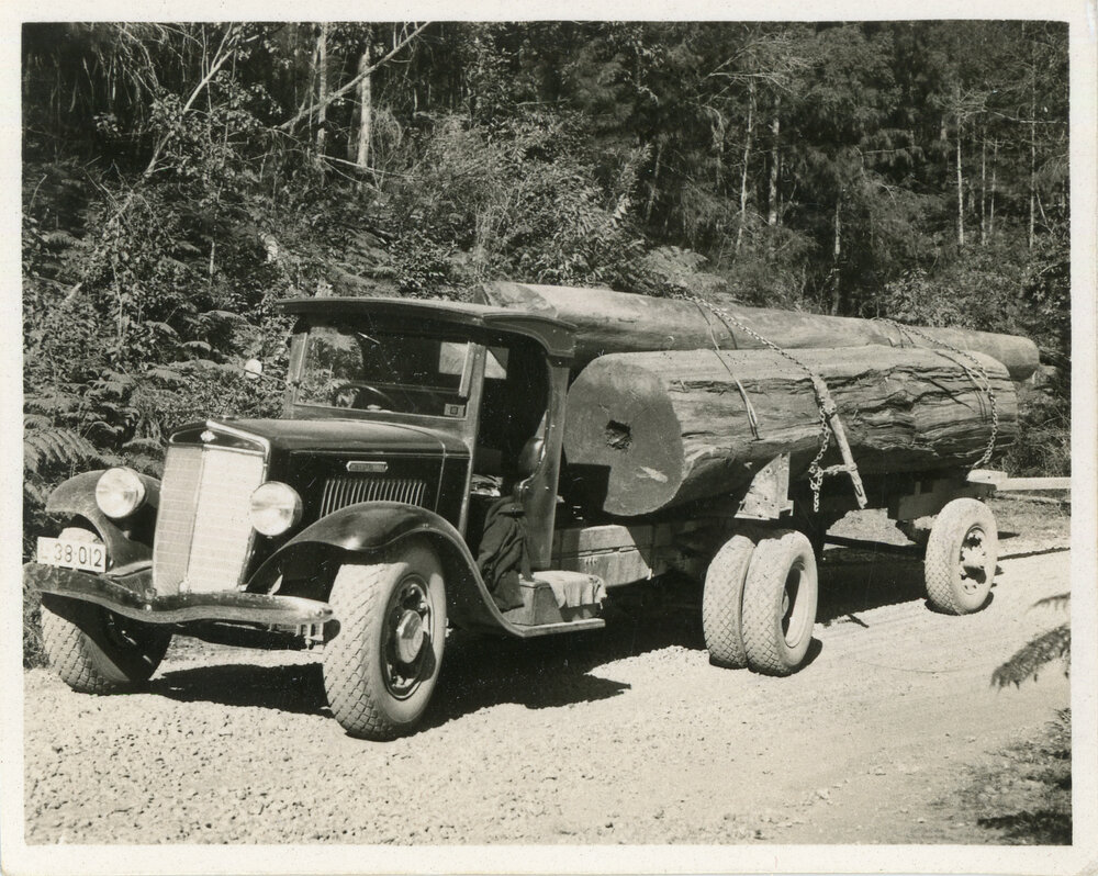 An International truck stacked with logs, 1936
