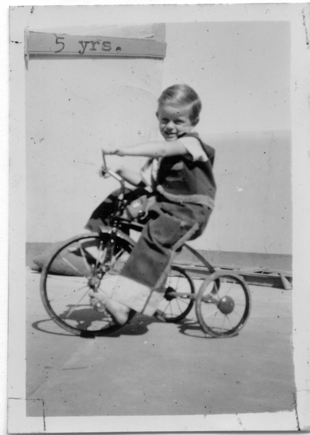 Jeffrey Hobman rides his tricycle on South Solitary Island, 1951