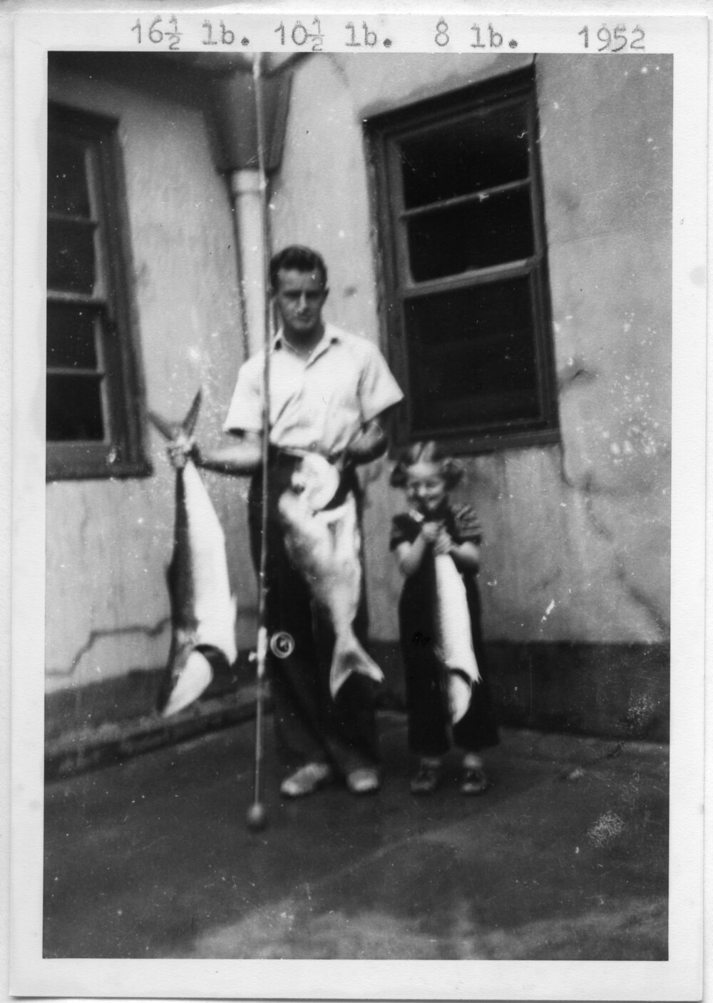 Lightkeeper Kevern Hobman and daughter Shirley with fish, 1952