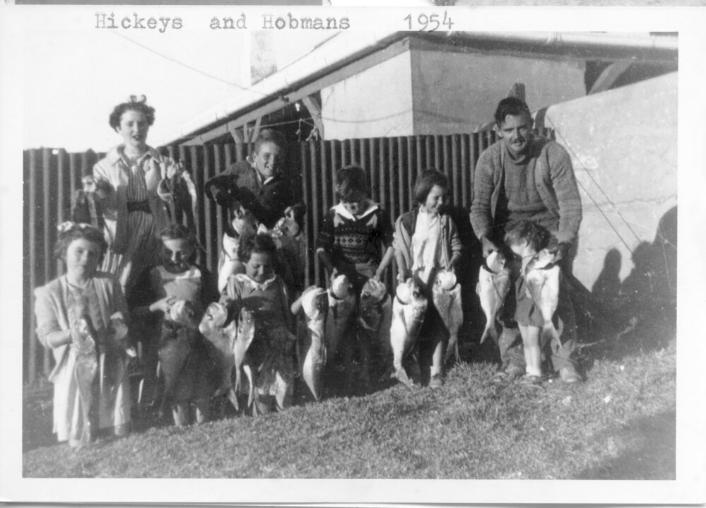 The Hobman and the Hickey families display their catch, 1954