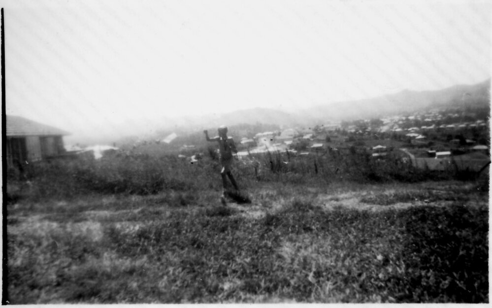 Robert Nicol flying a kite in front of his home at 4 Solitary Street, 1950s 