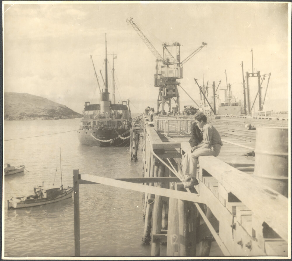 Loading timber onto the Kopua moored at the jetty, c.1955