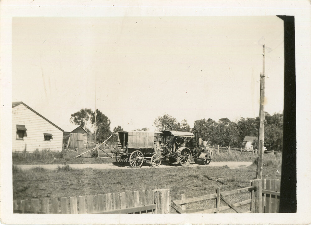 Steam tractor pulling a wagon along Lyons Road, c.1940