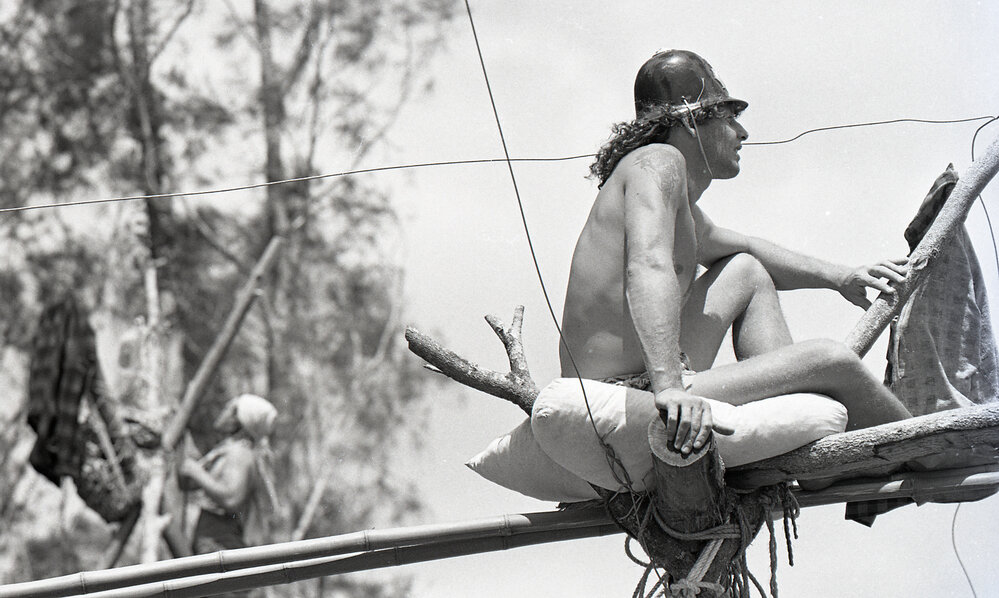 A protestor perches on top of a teepee, 25 November 1991