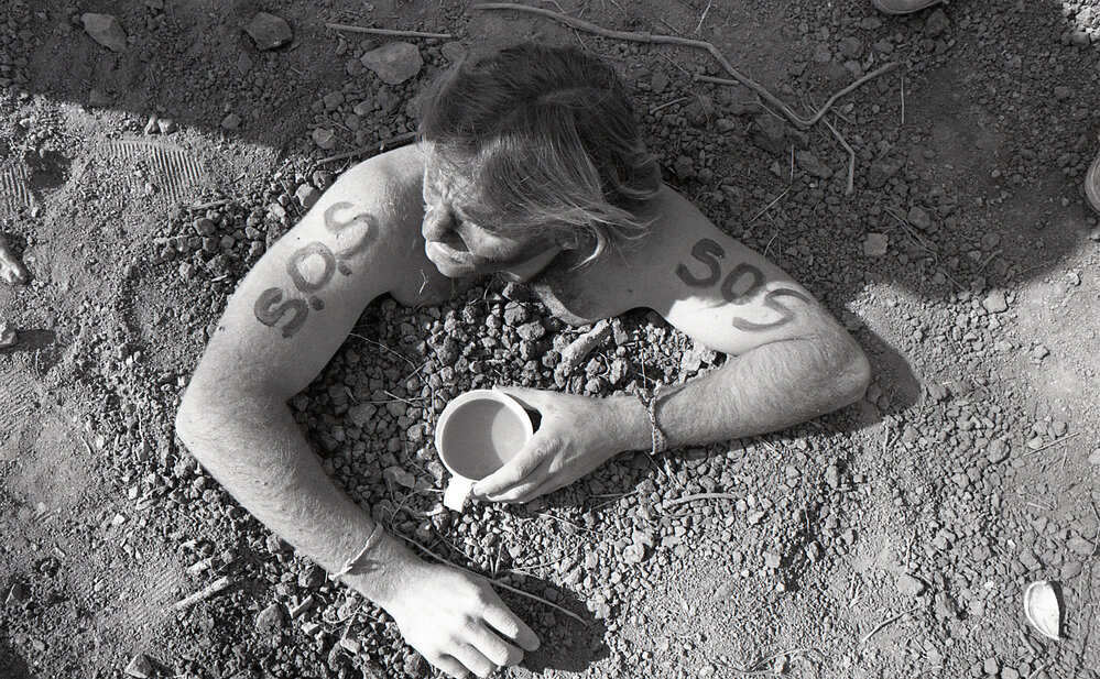 A protestor is buried up to his neck, late 1991