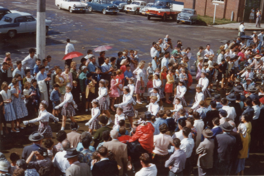Viewing a parade along High Street after a storm, c.1960