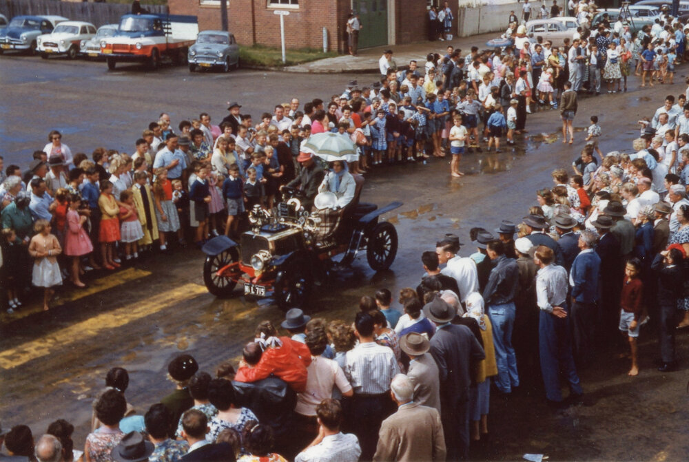 Viewing a parade along High Street after a storm, c.1960