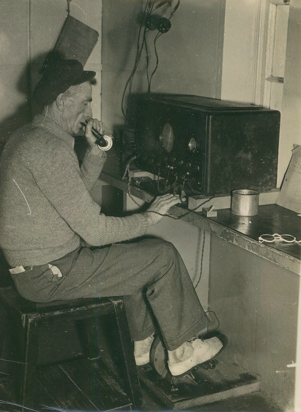 Lightkeeper Jim Duncan using a pedal radio at South Solitary Island lighthouse, 1946